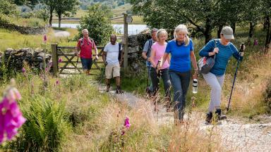 A group of people walking in the countryside.