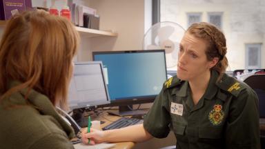 Advanced rotational paramedic consulting with a patient in a GP surgery