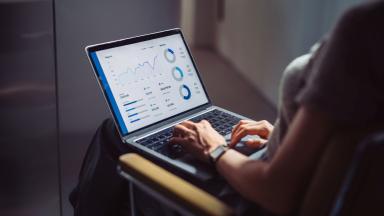 Woman looking at data dashboard on laptop