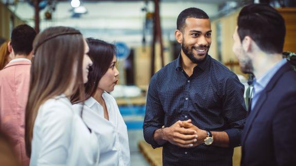 A diverse group of delegates having a conversation at a conference.