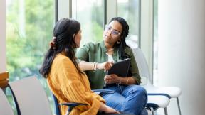 Healthcare professional consulting with a patient in a light, airy space