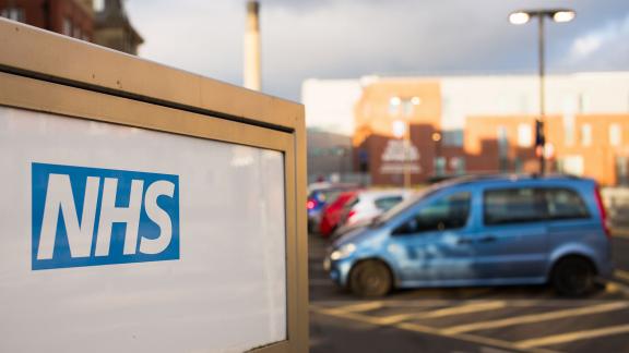 An NHS sign in a car park.