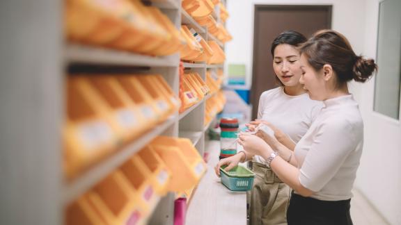 Two pharmacists reviewing a prescription.