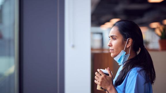 Tired nurse looking outside the window