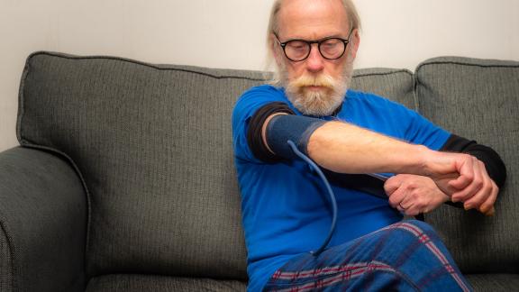 An elderly patient checking his blood pressure.