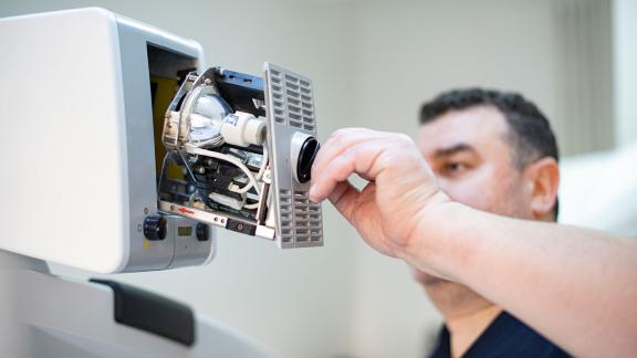 A technician fixing a machine.