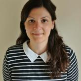 Accessibility description: A photo of Dr Eirini Kontou, a white woman with dark brown hair, pictured smiling and looking towards the camera.